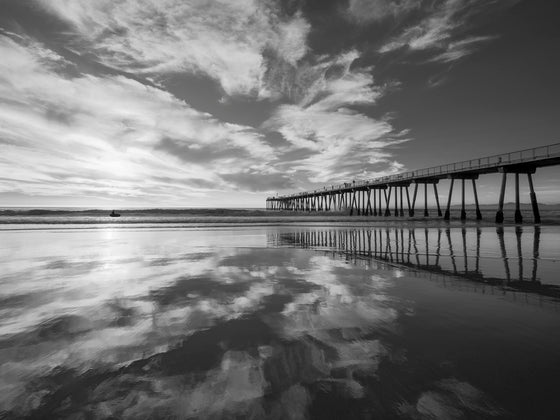 Sunset, Hermosa Beach Pier, with clouds reflecting on the sand, in black and white