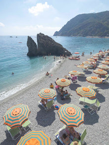  Monterosso beach with colorful umbrellas in the Italian summertime.
