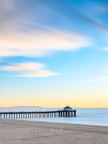  A sunrise with blurred yellow clouds and calm blue water shot with long exposure to create a blurred effect.