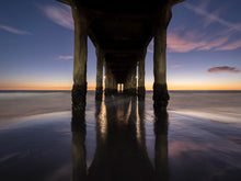  Manhattan Beach pier photo taken from underneath the pier ,after sunset during the blue hour. This is a long exposure and the sky is ombre above the horizon.