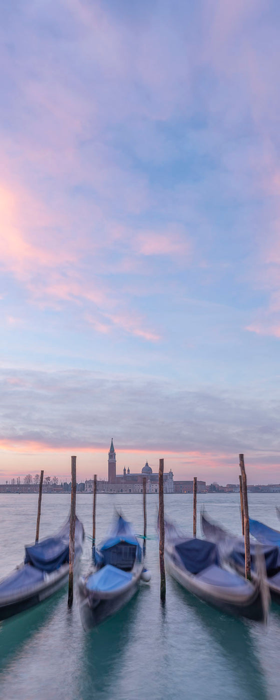 Vertical panoramic photo of gondolas and the Church of San Giorgio Maggiore, on the Grand Canal in Venice Italy