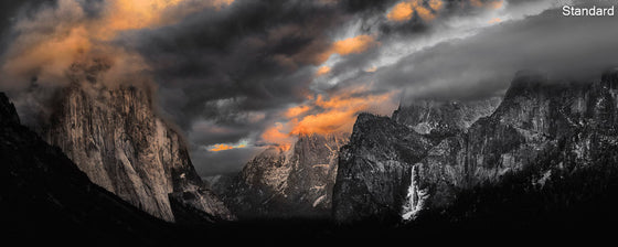 A panoramic image of the Yosemite clearing during sunset, featuring a waterfall and orange clouds