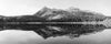 Beautiful black ad white Alpine Mirror image from a Colorado Alpine lake with mountaintops and trees..
