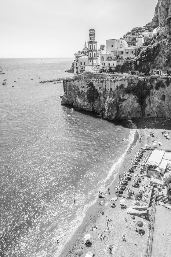 Black and white image of the Amalfi Coast with a small beach and a Beach Club taken from above.