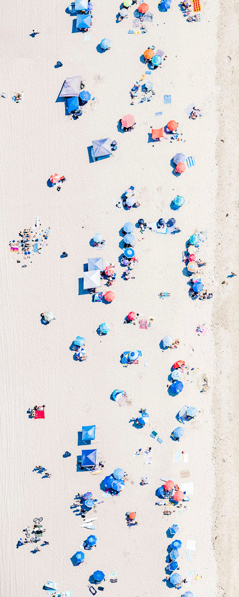 Color vertical panoramic aerial photo of Manhattan Beach in Los Angeles with beach umbrellas and sand