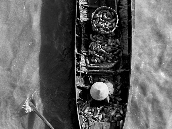 Boat with vegetables in the Mekong Delta in Vietnam, black and white