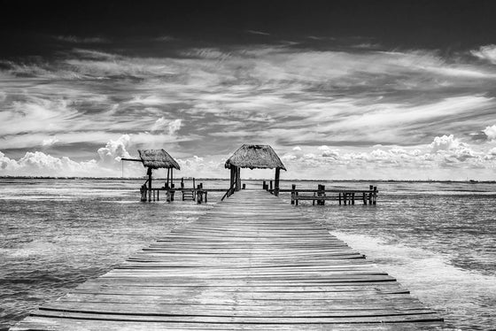 A dock from the coast of Isla Mujeres that highlights the clouds in the background.