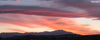 panoramic photograph taken during sunset in the desert in Palm Springs featuring pink clouds and a mountain range