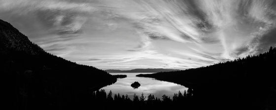 A panoramic image of Emerald Bay in Lake Tahoe, California at sunset in black and white