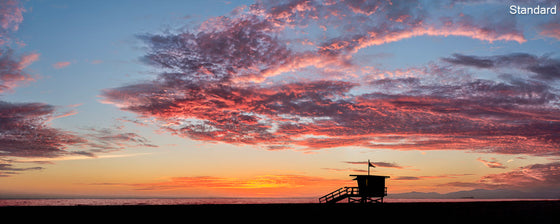 A panoramic photo of a lifeguard tower in Manhattan Beach (Los Angeles California) at sunset.