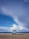 A photo of a lifeguard tower in Manhattan Beach (Los Angeles California) with dramatic clouds overhead