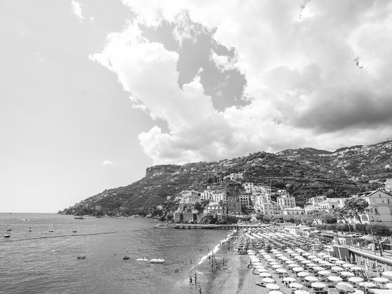 Amalfi Town on the Amalfi Coast with Beach Clubs and a big white cloudscape.