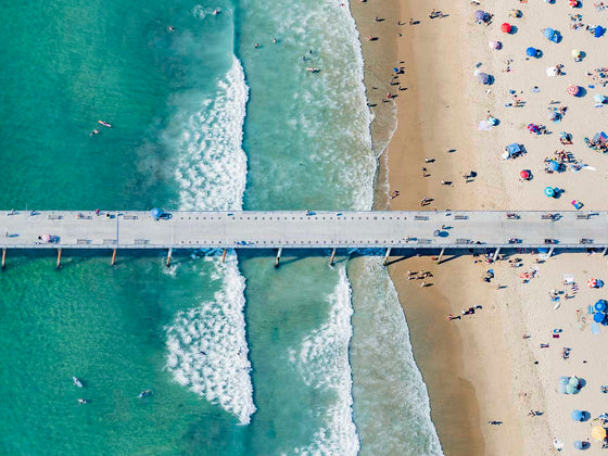 Color aerial photo of Hermosa Beach Pier in Los Angeles with beach umbrellas