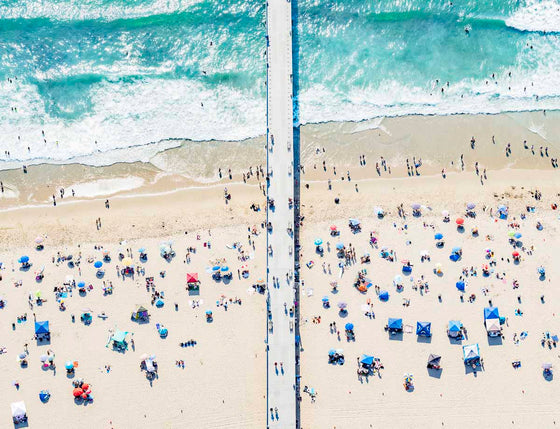 Color aerial photo of Hermosa Beach Pier in Los Angeles with beach umbrellas