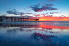  The Hermosa Beach California pier after sunset during the blue hour at low tide with the clouds and sunset reflecting in the ripples in the sand