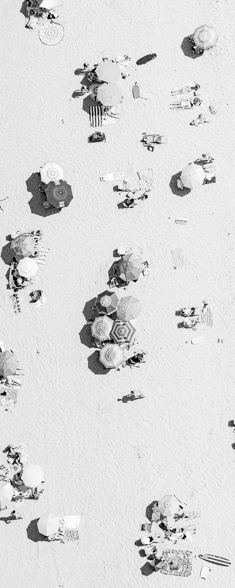 Vertical panoramic black and white aerial photo of Manhattan Beach in Los Angeles with beach umbrellas