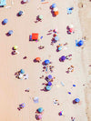 Color aerial photo of Manhattan Beach in Los Angeles with red and blue beach umbrellas
