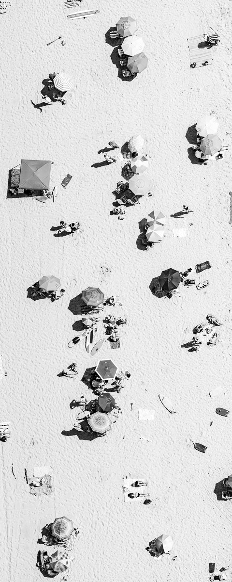 Vertical panoramic black and white aerial photo of Manhattan Beach in Los Angeles with beach umbrellas