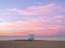  A Manhattan Beach lifeguard tower, in Los Angeles, at sunrise, with soft clouds over the Pacific Ocean