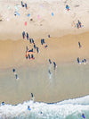 Color aerial photo of Manhattan Beach in Los Angeles with surfers and their shadows