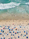 Color aerial photo of Manhattan Beach in Los Angeles with beach umbrellas and the ocean