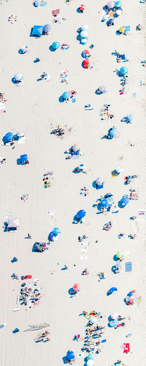 Vertical panoramic color aerial photo of Manhattan Beach in Los Angeles with beach umbrellas, sand