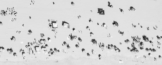 Black and white aerial photo of Manhattan Beach in Los Angeles with beach umbrellas