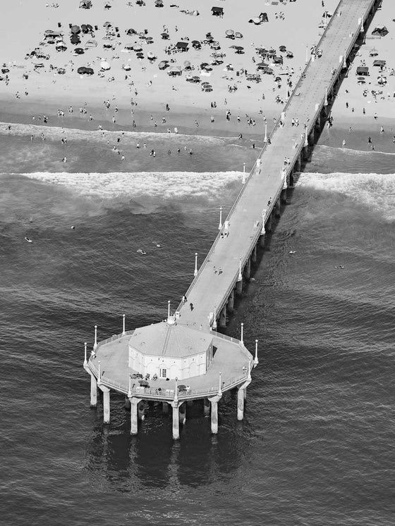 Black and white aerial photo of the Manhattan Beach Pier in Los Angeles California