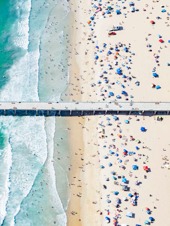 Colorful aerial photo of Manhattan Beach Pier in Los Angeles with beach umbrellas, sand and the ocean