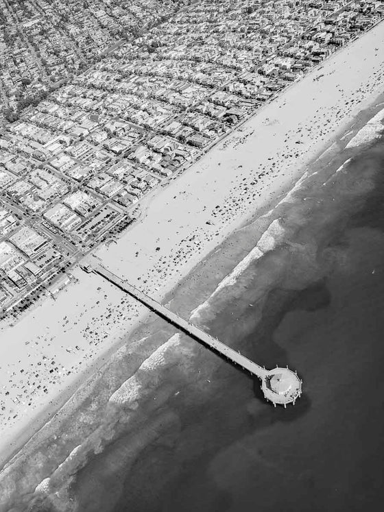Black and white aerial photo of Manhattan Beach and the Manhattan Beach Pier in Los Angeles California