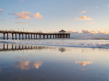  Manhattan Beach California pier, at sunset, with clouds reflected on the sand in the beach