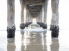 Photo of tunnel view from under the Manhattan Beach Pier minimalist. It is overcast and the colors are muted colors white, beige, brown and grey.