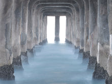  Photo taken from underneath the Manhattan Beach pier. It is a long exposure and the ocean looks flat and there is mist on it.