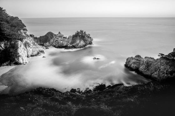 McWay Falls in Big Sur California, at sunset, with a long exposure to give the water a smooth zen-like feeling, in black and white