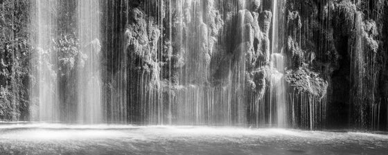 horizontal panoramic photo of a moss covered waterfall, ultra high resolution large format photo, in black and white