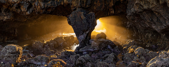 Light streaming through a cave in Palos Verdes California, sunset, panoramic