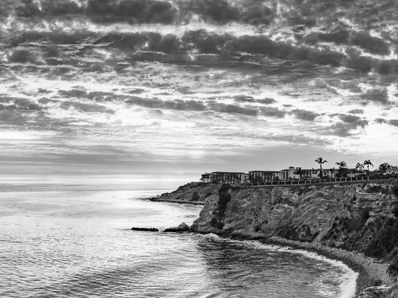 Sunset from the cliffs of Palos Verdes California, with the Pacific Ocean and Terranea Resort, in black and white