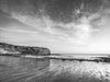 Sunset from the beach in Palos Verdes California, with the Pacific Ocean and a low tide beach, in black and white