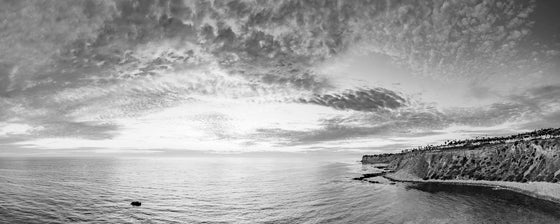 Sunset from the cliffs of Palos Verdes California, with the Pacific Ocean and Catalina Island in the distance, panoramic, in black and white