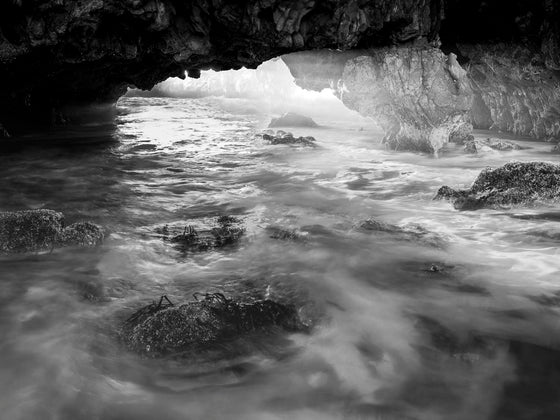 sun rays streaming through a cave in Palos Verdes California, in black and white