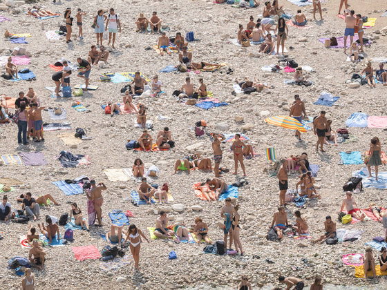 Sunbathers on the beach in Polignano al Mare Italy, on the Adriatic