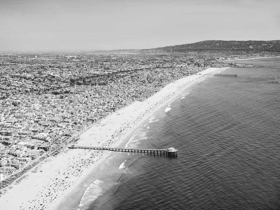 Black and white aerial photo of the South Bay in Los Angeles, including the Manhattan Beach Pier, Hermosa Beach Pier, Redondo Beach and Palos Verdes Peninsula