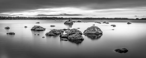 long exposure black and white photo of a lake and rocks in Sweden