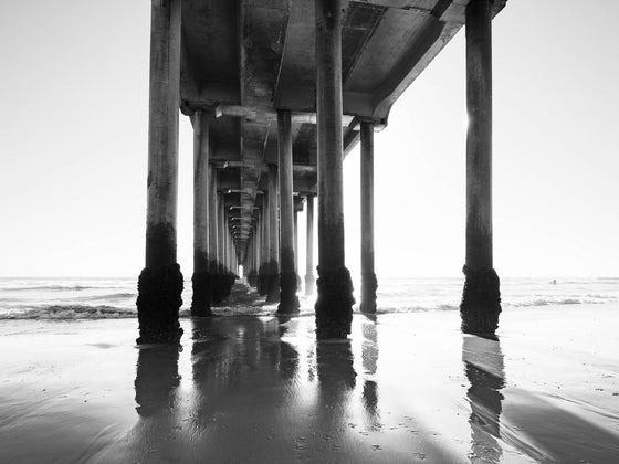 Under the Huntington Beach Pier, low tide, black and white