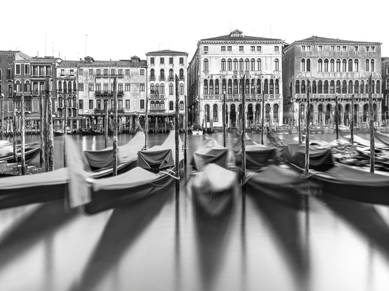 Black and white photo of gondolas on the grand canal in Venice Italy
